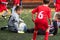 Boys kicking soccer ball at sports field