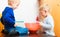 Boys kids baking cake. Children beating dough with wire whisk.