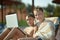 Boys with laptop near pool