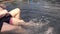 Boys legs splashing water in pool, summer holiday