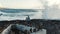 Boys look at the big waves crashing on the pier. The brothers contemplate the splashes of waves crashing on the rocky shore during