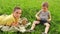 Boys lying on grass with ducks. Happy children playing with animals.