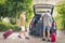 Boys packing luggage in car