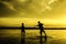 Boys play beach soccer during sunset sunrise