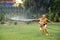 Boys play water in garden