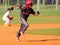 Boys playing baseball, running to base