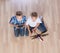 Boys playing with flying helicopter model at home using remote control