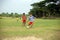 Boys playing football on the ground. A teen boy or kid kicking the football off the ground and another child is ready to kick