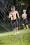 Boys playing with lawn sprinkler