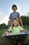 Boys playing in the plane using a garden carts summer outdoors