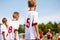 Boys playing soccer football match on football field. Kids kicking ball