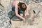 Boys playing with stones at the mountain river