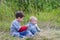 Boys playing together in the grass in the country