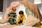 Boys playing toy blocks in kids tent at home