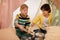 Boys with pots playing music in kids tent at home