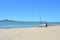 boys pulling small racing yacht out of water at Kohimarama beach