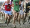 Boys racing cross country in the mud