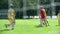 Boys in red and yellow dress playing soccer and hitting goal