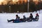 The boys are rolling down the slope snowy mountains in winter sledging