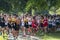 Boys running in a high school cross country race crosing a path under trees