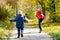 Boys running towards her mother. Autumn Park. View from the back