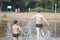 Boys running on the water splashing water drops concept camping