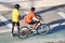 Boys with skates and bicycle in relax and sport