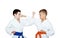 Boys sportsmen with orange and blue belt training paired exercises