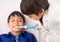 Boys teach each other how to use electric toothbrush