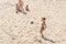 Boys teenagers playing soccer on the beach