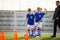 Boys Training Football on Pitch Witch Youth Coach. Group of Young School Age Boys On Training Session With Youth Coach