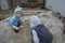 Boys of two and seven years old play in the sandbox.