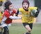 Boys, under 8 aged, red/yellow jacket play rugby