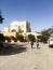 Boys walk along the street against the background of the building. Street of the Arab city. Jordan