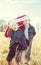 Boys wearing a giant Christmas Santa hat