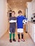 Boys will be boys. Portrait of two young boys in sports clothing standing indoors with a soccer ball.