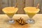 Boza and cinnamon sticks, traditional Turkish cuisine drinks, on wooden background