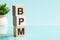 Bpm abbreviation - business process management, on wooden cubes on a light background