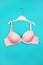 Bra on hanger on blue background