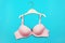 Bra on hanger on blue background