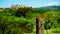 Bracciano Castle seen through barbed wire of an agricultural field with selective focus