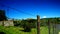 Bracciano Castle seen through barbed wire of an agricultural field with selective focus