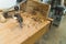 Brace - old woodworking tool instead of automatic drilling machine - placed on wooden table next to wood filings. No