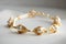 bracelet with delicate pearls and gold accents on white background