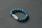 Bracelet made of natural stones. Blue apatite and rock crystal dZi bead. Handmade jewelry. Handmade bracelets on a black modern