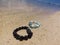 Bracelets from amazonite, garnet, agate on a beach