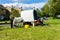 Bradford on Avon Wiltshire May 22nd 2019 An Irish cob/gypsy vanner grazing next to a plain vardo caravan