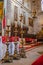 Braga, Portugal - December 28, 2017: Se de Braga Cathedral. Three tall candlesticks in main chapel altar and choir stalls. Oldest