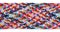 A braid of multi colored sewing threads on a white background