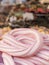 Braid of pink and white marshmallow in the foreground. Variety o